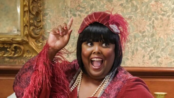 danielle-pinnock-s-alberta-smiles-and-holds-up-a-finger-in-ghosts_11zon