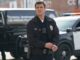 Nathan fillion in a police unifo